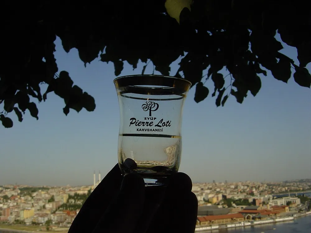 A tulip glass of Turkish tea above the Istanbul skyline