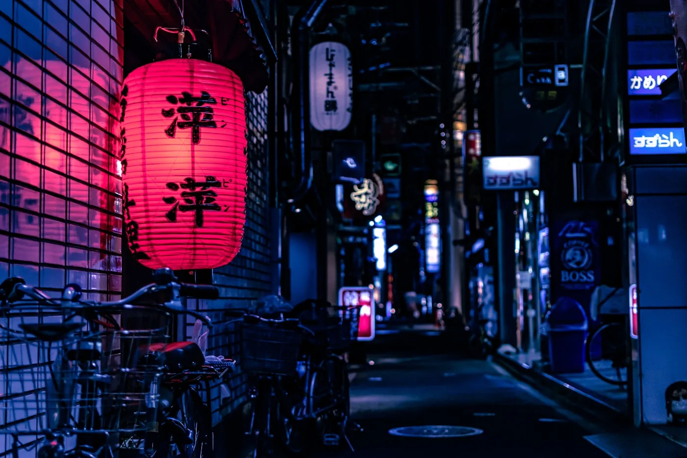 A narrow Japanese alley at night under a red paper lantern