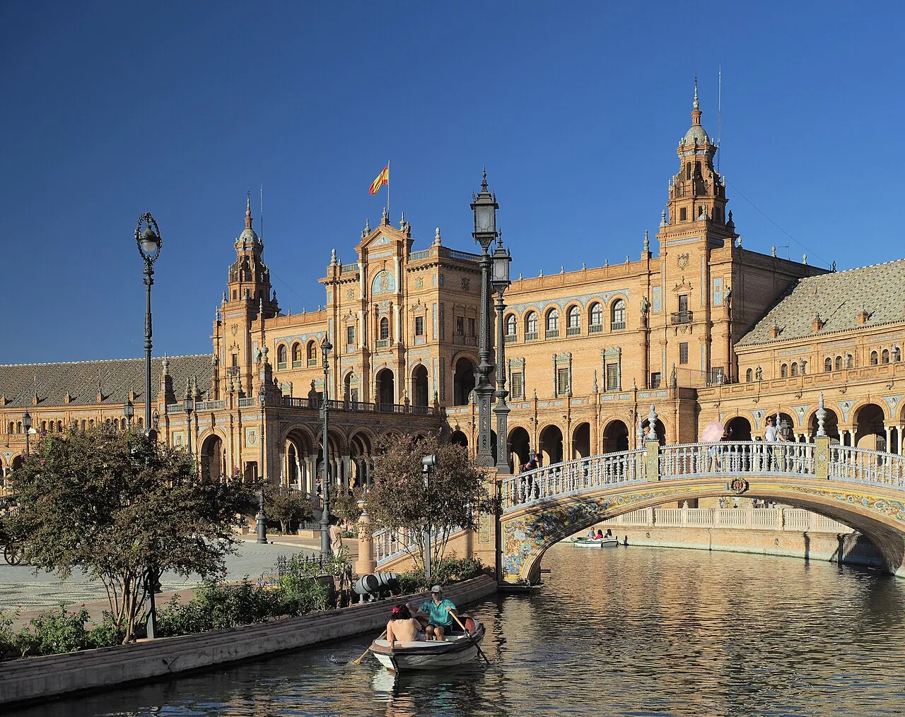 The Plaza de España in Seville, with a rowing boat on the canal below its bridges