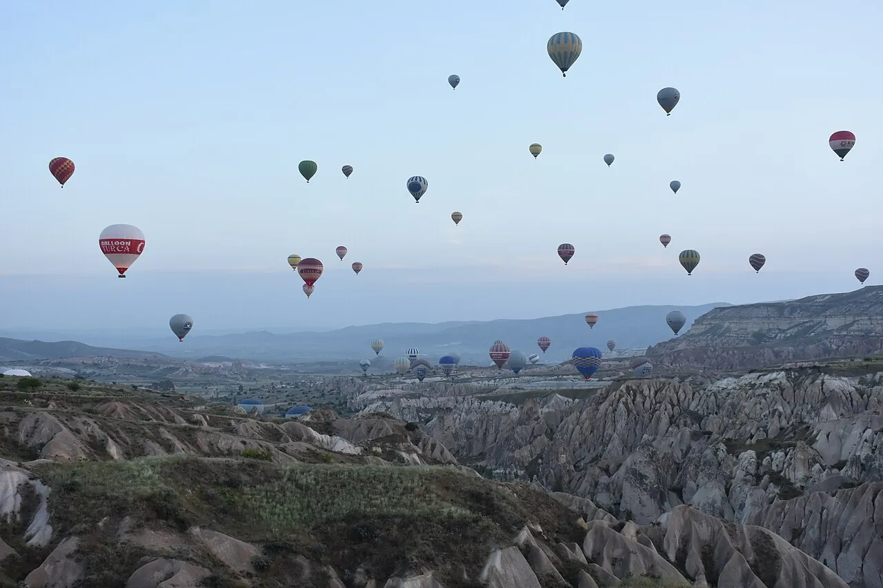 Hot air balloons rising over the valleys near Goreme in Cappadocia at dawn