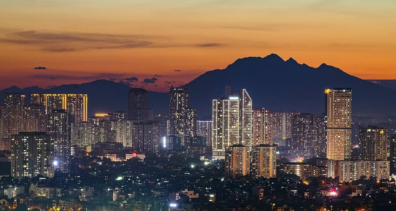 Hanoi at dusk, with Ba Vì mountain behind the city