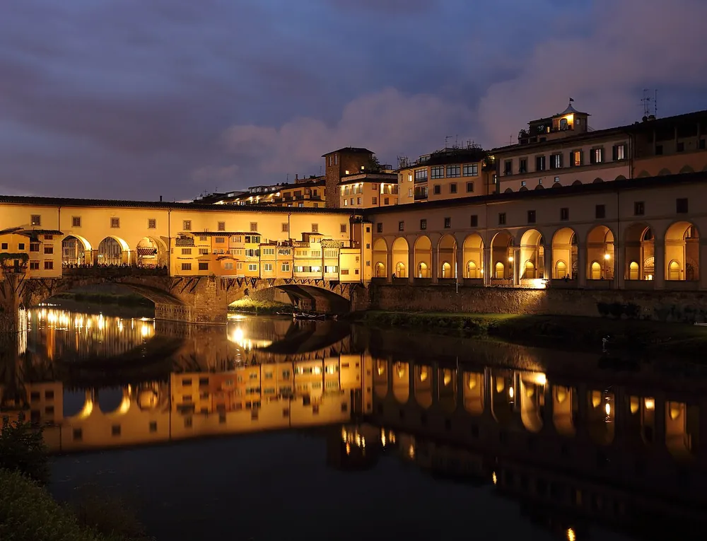 The Ponte Vecchio reflected in the Arno at dusk