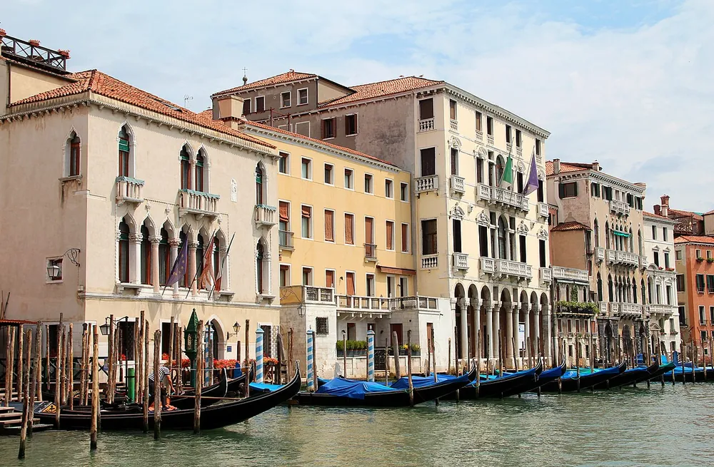 Gondolas moored below Venetian palazzi on a canal