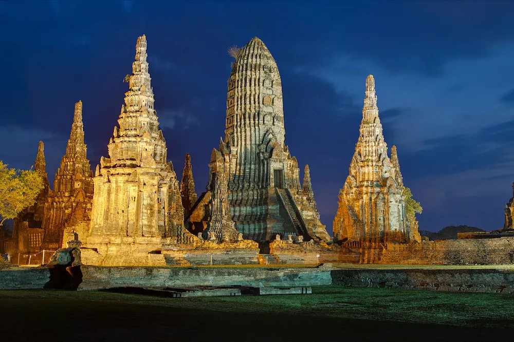 The prangs of Wat Chaiwatthanaram at Ayutthaya, floodlit at dusk