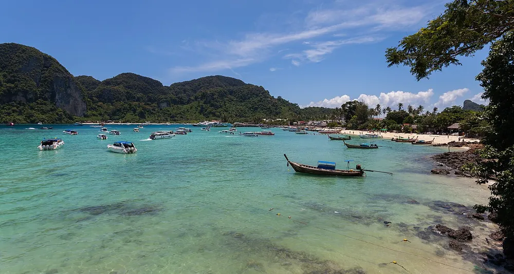Longtail boats moored in the shallow bay at Ko Phi Phi Don