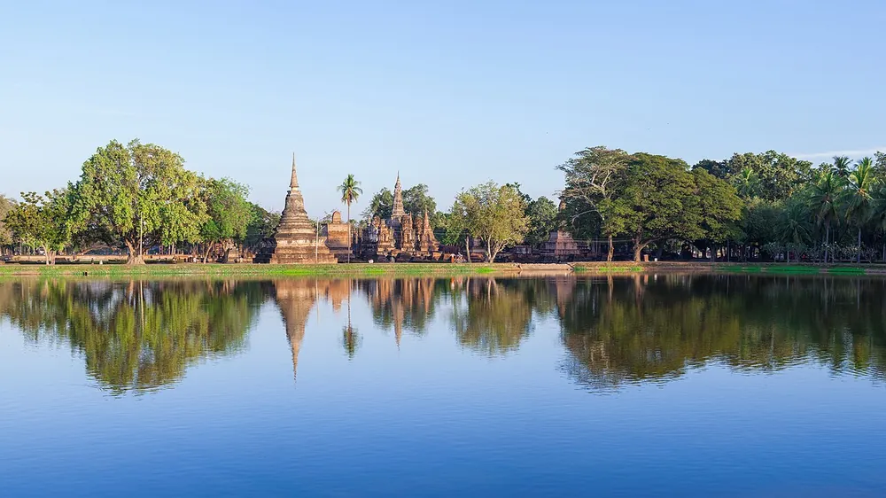 Ruins reflected in still water at Sukhothai Historical Park