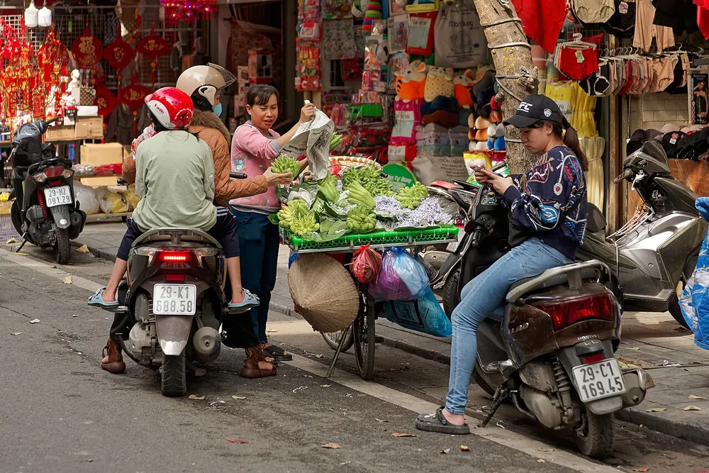 A street seller and motorbikes in Hanoi's Old Quarter